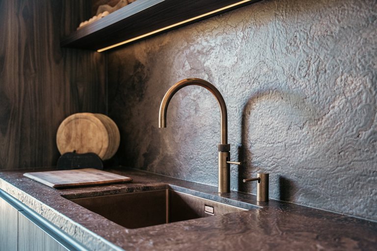 Detail van de kraan en het natuursteen in de keuken